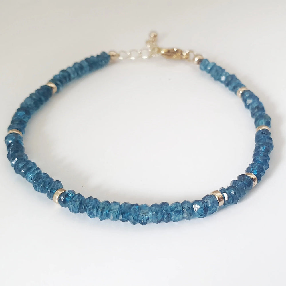 With its deep ocean blue and shimmering colour, the beauty of Topaz is captivating.   This bracelet is made of 4mm dainty Topaz gemstones with findings in 14k Gold Filled and Surgical Steel - perfect for sensitive skin.  Discreet yet sparkly, we love how elegant this bracelet is! It is also lightweight, so you can wear it anytime, anywhere.  Try mixing and matching it with our other gemstone bracelet styles to create a stacking effect. 