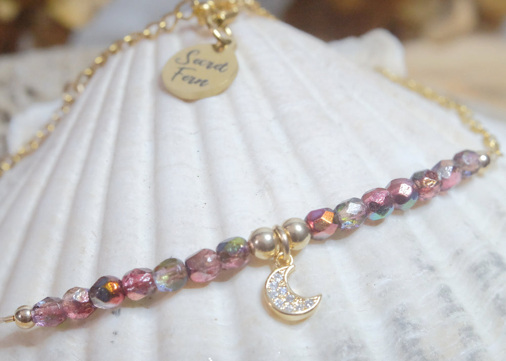 Raspberry red iridescent rustic glass bead with a rhinestone moon charm anklet on a gold plated s. steel and gold filled elements
