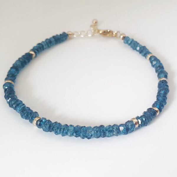 With its deep ocean blue and shimmering colour, the beauty of Topaz is captivating.   This bracelet is made of 4mm dainty Topaz gemstones with findings in 14k Gold Filled and Surgical Steel - perfect for sensitive skin.  Discreet yet sparkly, we love how elegant this bracelet is! It is also lightweight, so you can wear it anytime, anywhere.  Try mixing and matching it with our other gemstone bracelet styles to create a stacking effect.