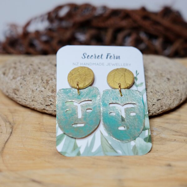 Weathered African mask brass on a foliage-stamped polymer clay stud.  Earring posts are hypoallergenic - surgical steel.