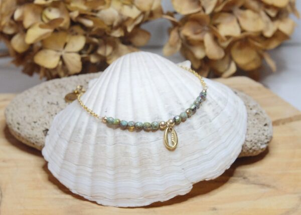 Conch charm anklet on a Gold plated surgical steel chain, tortoise hand fired rustic glass beads, rhinestone charm and gold filled findings.