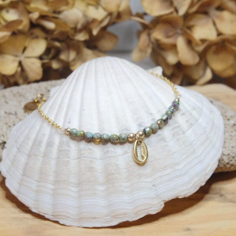 Conch charm anklet on a Gold plated surgical steel chain, tortoise hand fired rustic glass beads, rhinestone charm and gold filled findings.