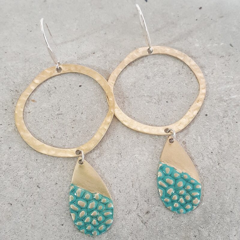 Hammered and textured brass with polished Sterling Silver posts. Earrings are finished with an organic washed Turquoise type of patina.