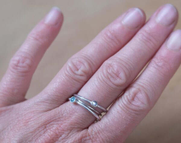 A minimalist sterling silver ring with a natural 3mm light blue tourmaline.