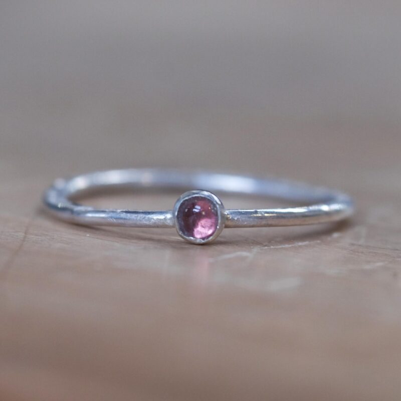 A minimalist sterling silver stacking ring with a natural 3mm pink tourmaline.