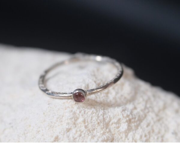 A minimalist sterling silver stacking ring with a natural 3mm pink tourmaline.
