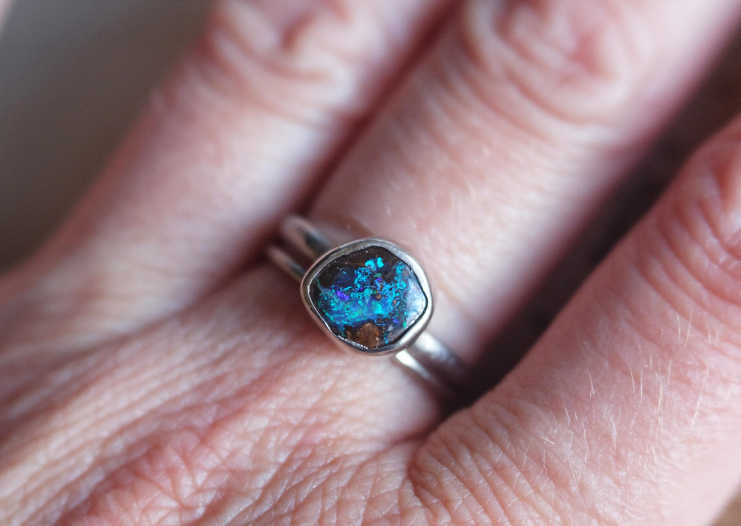 Koroit Opal Ring Handcrafted in my studio, this one-of-a-kind ring features an authentic Australian Koroit opal of 1.45 carats, set in solid sterling silver. This Queensland opal showcases a rich earthy matrix and electric blue and green flashes. This ring is an heirloom and a collector piece.