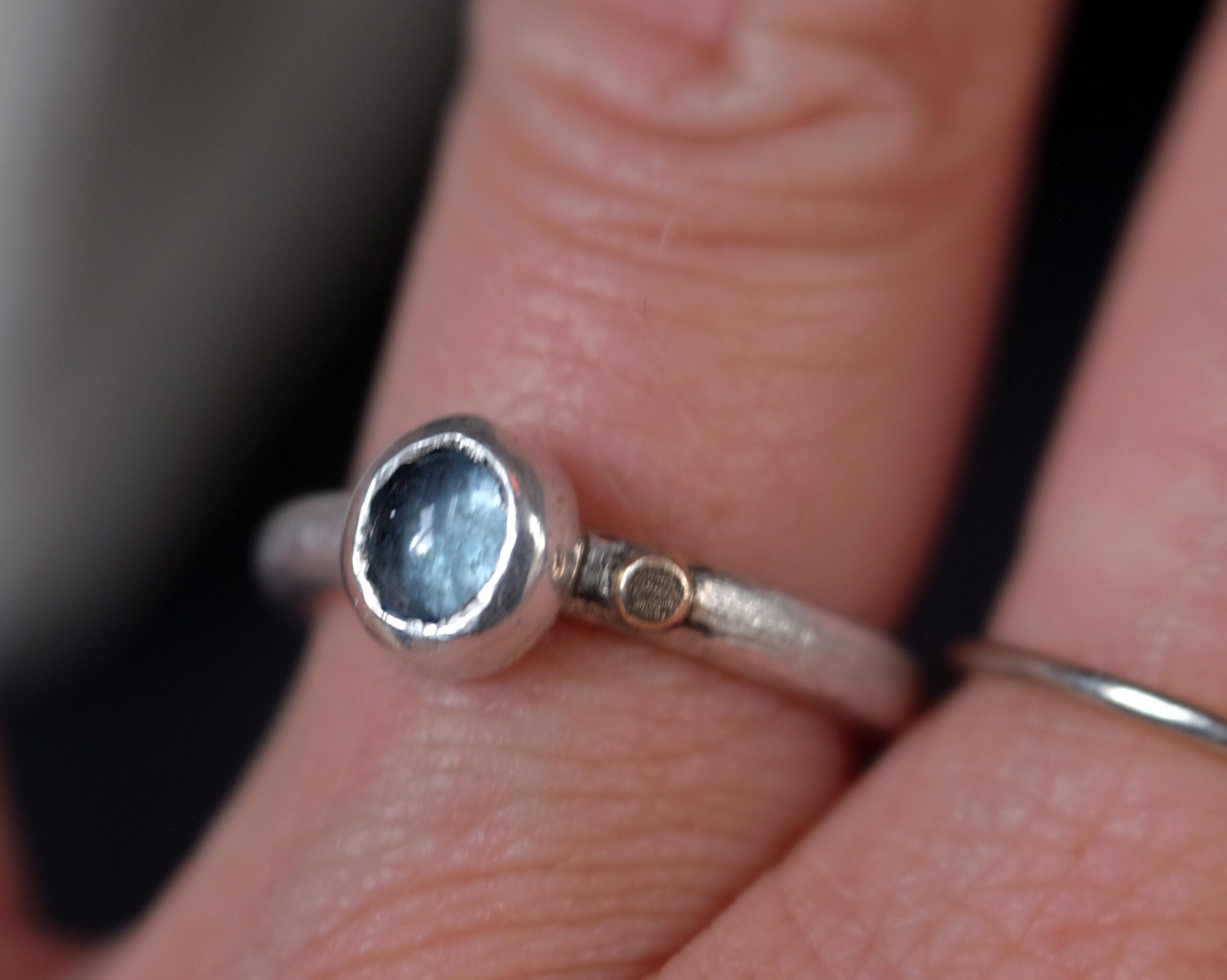 this one-of-a-kind ring features a pale blue moss aquamarine set in sterling silver, finished with a small 14k gold-filled dot as a gentle point of warmth